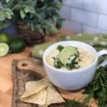 A bowl of green enchilada chicken soup.