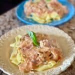 This is a picture of a tomato basil chicken sauce over pasta noodles.