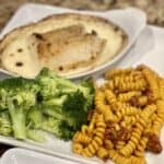 Baked cod with broccoli and pasta.