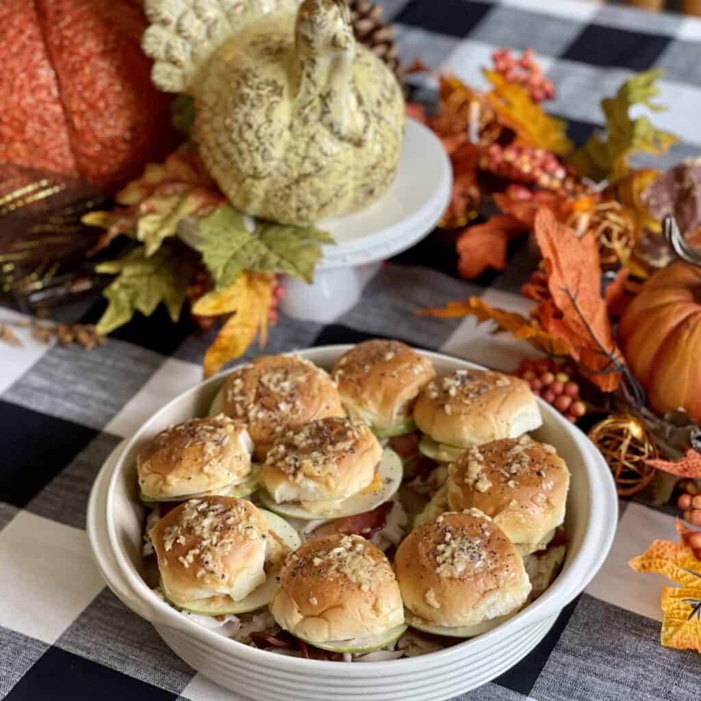 A pan of fall turkey sliders on a fall decorated table.