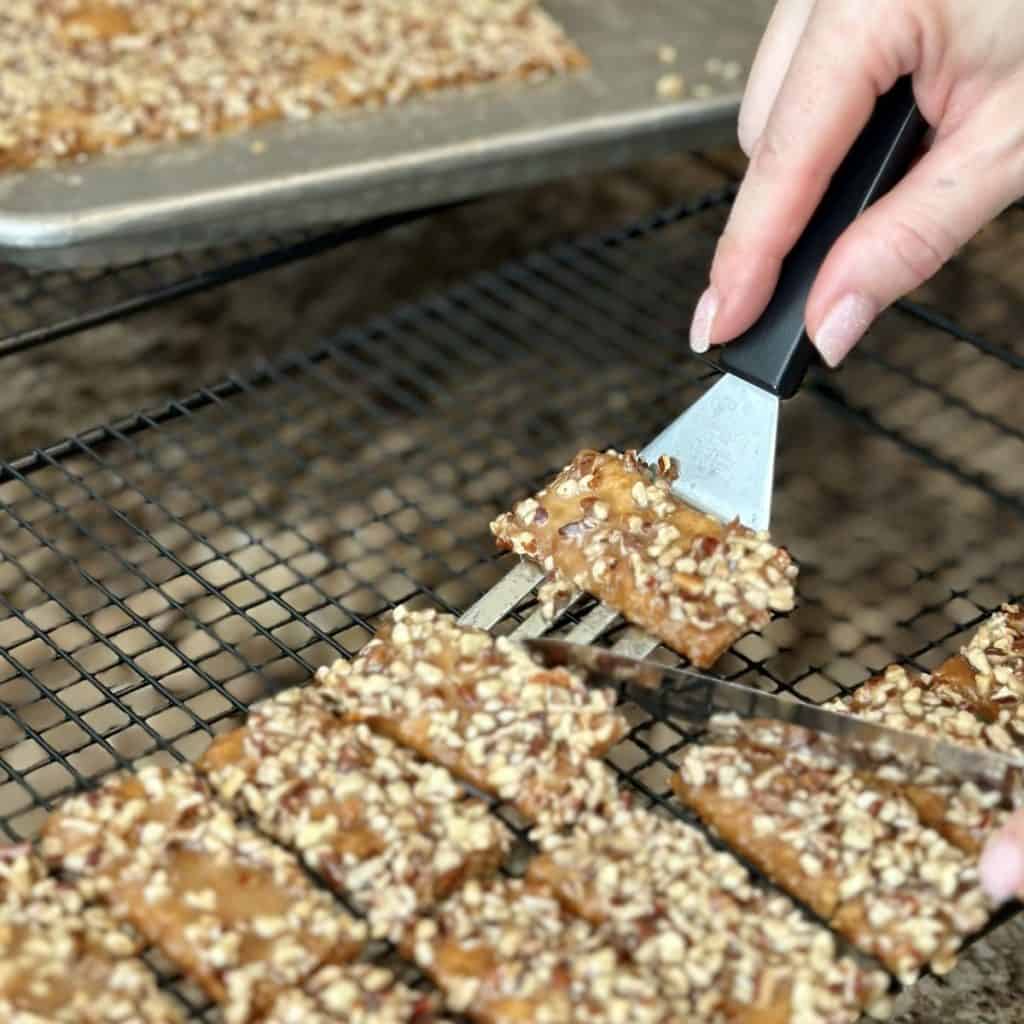 Placing toffee crackers on a cooling rack.