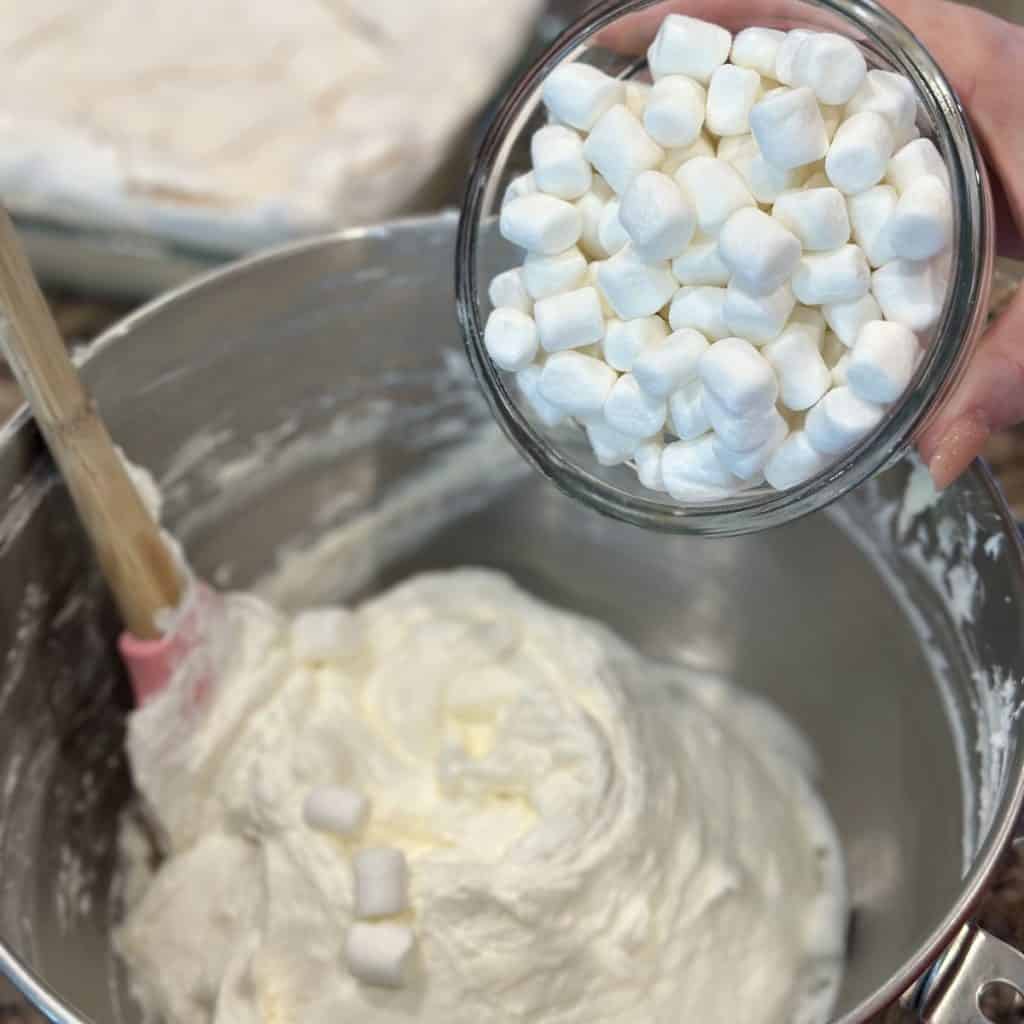 Fold marshmallows in a whipped topping filling. 