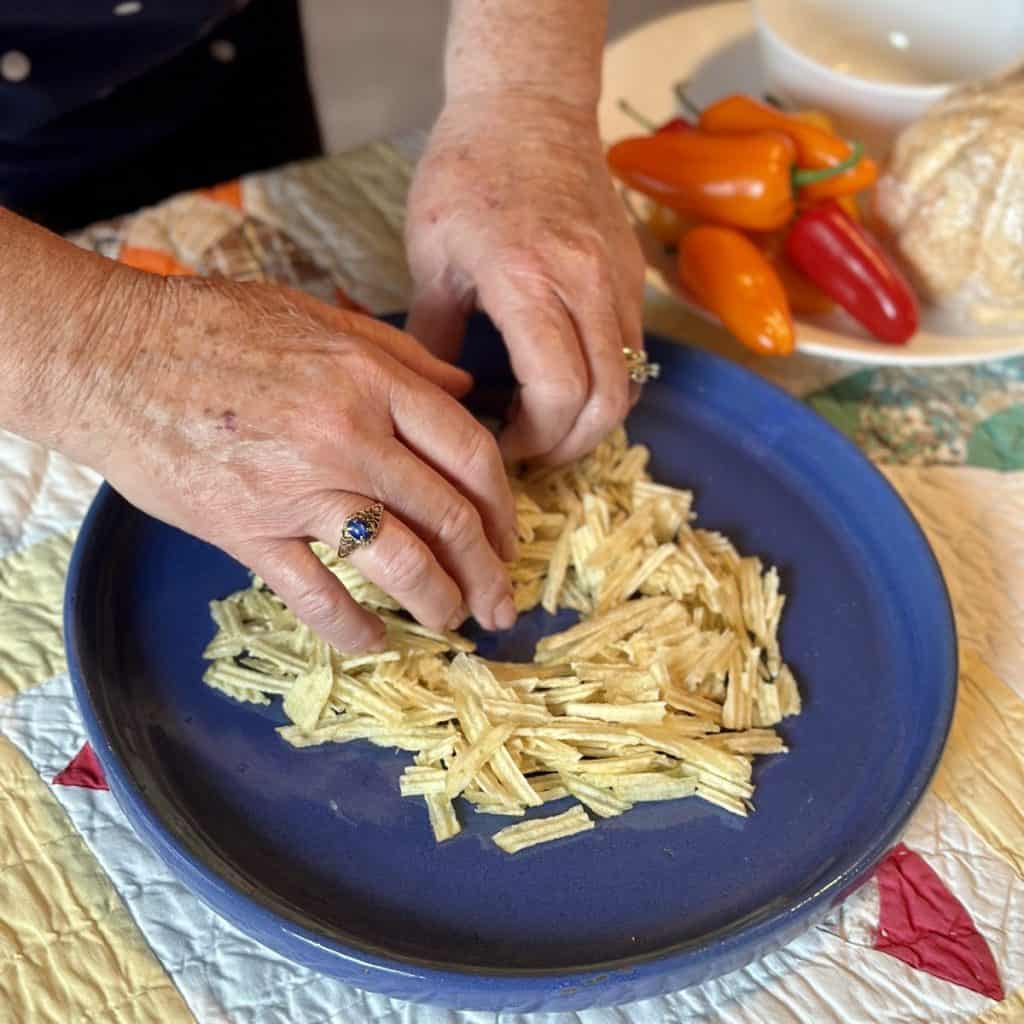 Spreading chips on a serving tray.