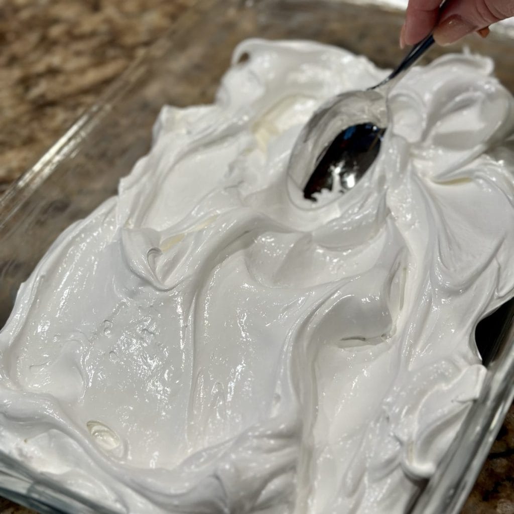 Spreading meringue in a baking dish.