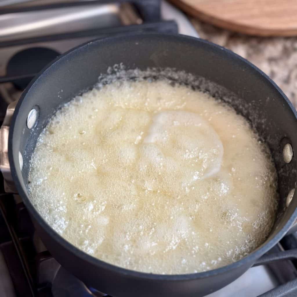 Boiling sugar and butter in a saucepan.