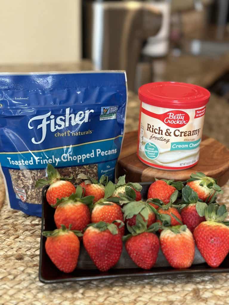 strawberries, cream cheese frosting and chopped pecans