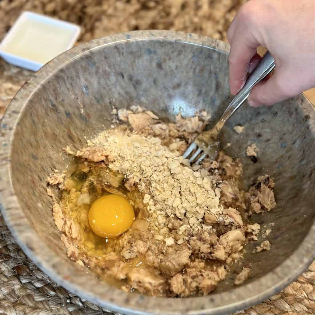 The ingredients for salmon cakes in a bowl.