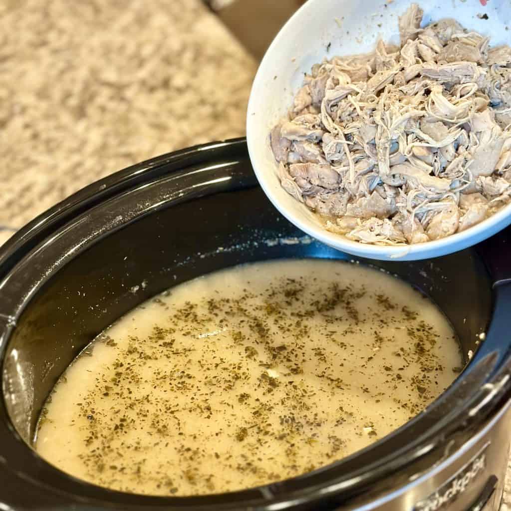 adding chicken to the crockpot