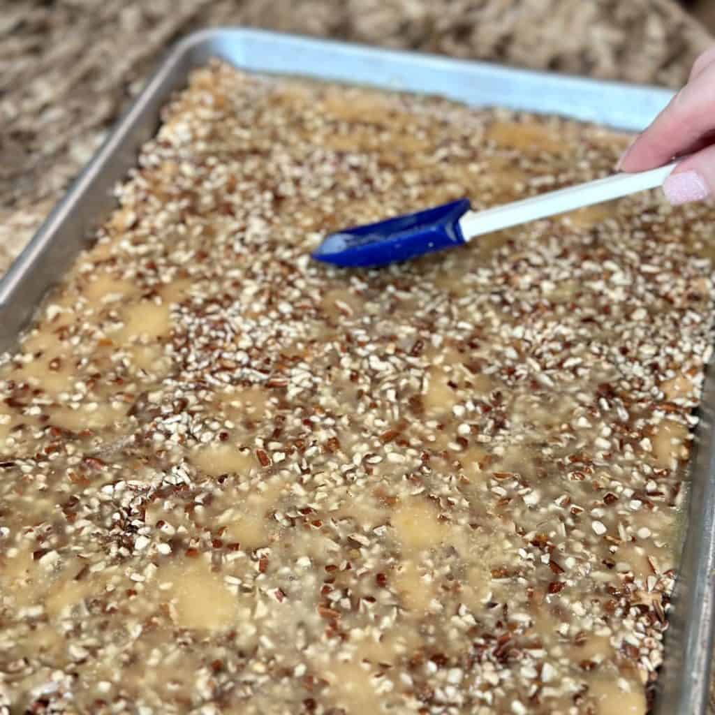 Spreading toffee on graham crackers.