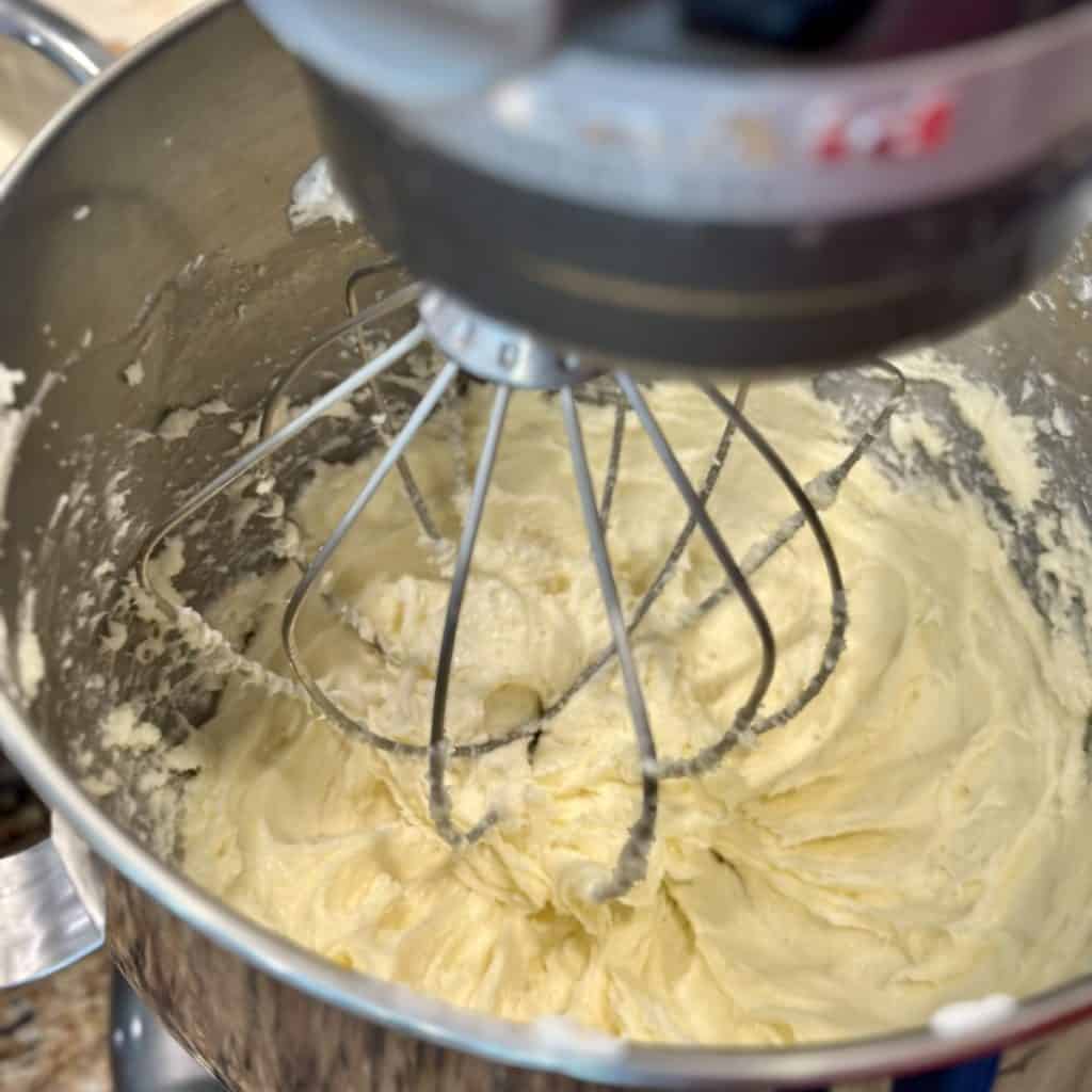 Whipping cream cheese in a mixer.