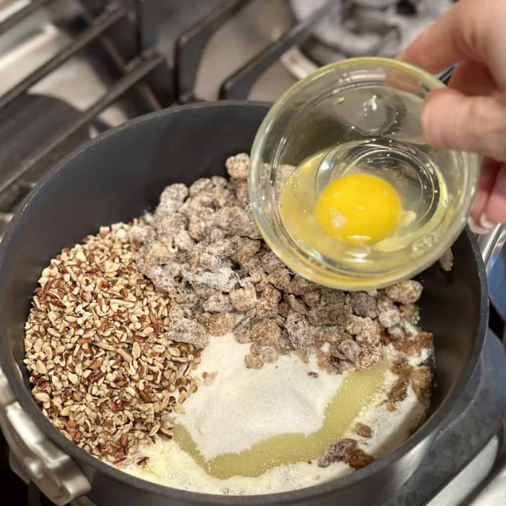 Mixing together ingredients in a pan for date balls.