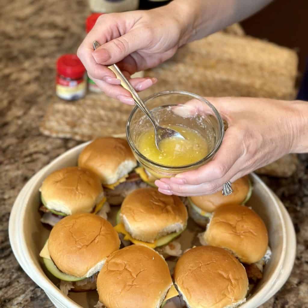 Mixing together a butter baste for turkey sliders.