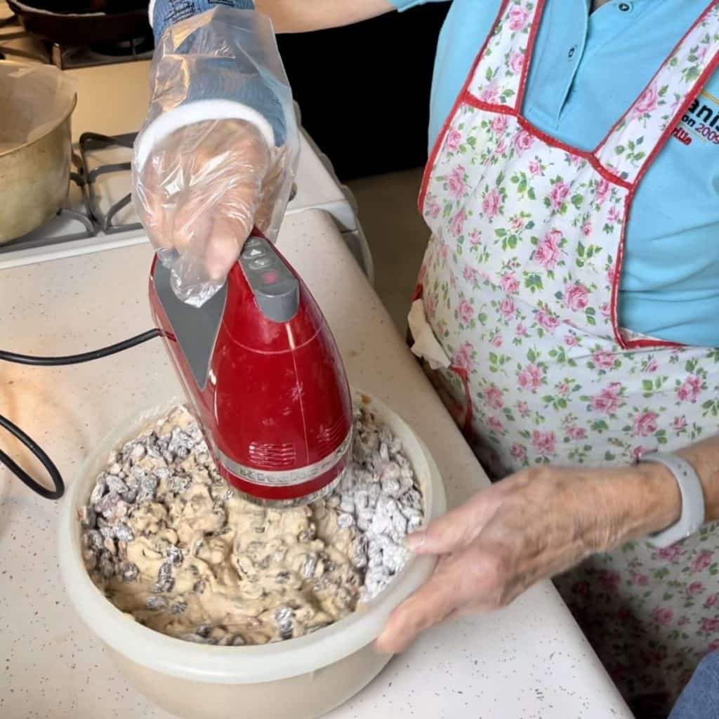 Mixing together ingredients for a jam cake.