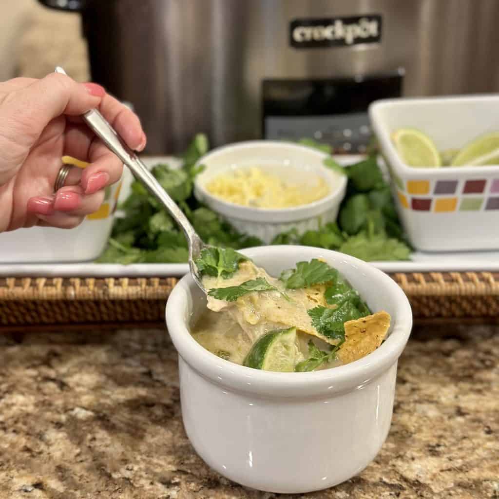 A bowl of dressed green enchilada chicken soup