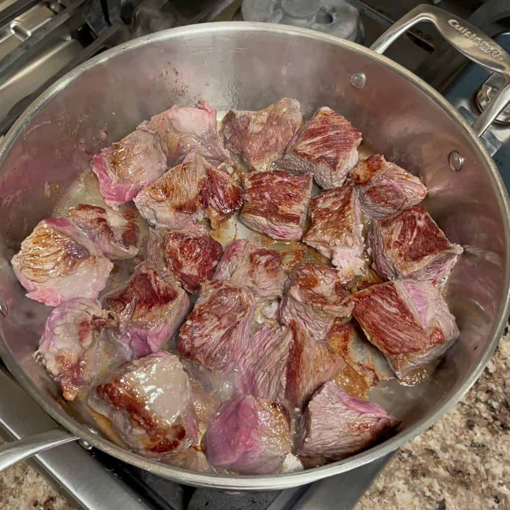beef chunks browning in a skillet