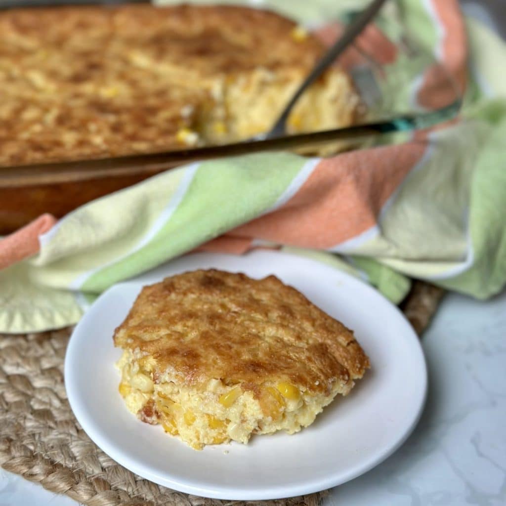 A serving of country scalloped corn on a saucer.