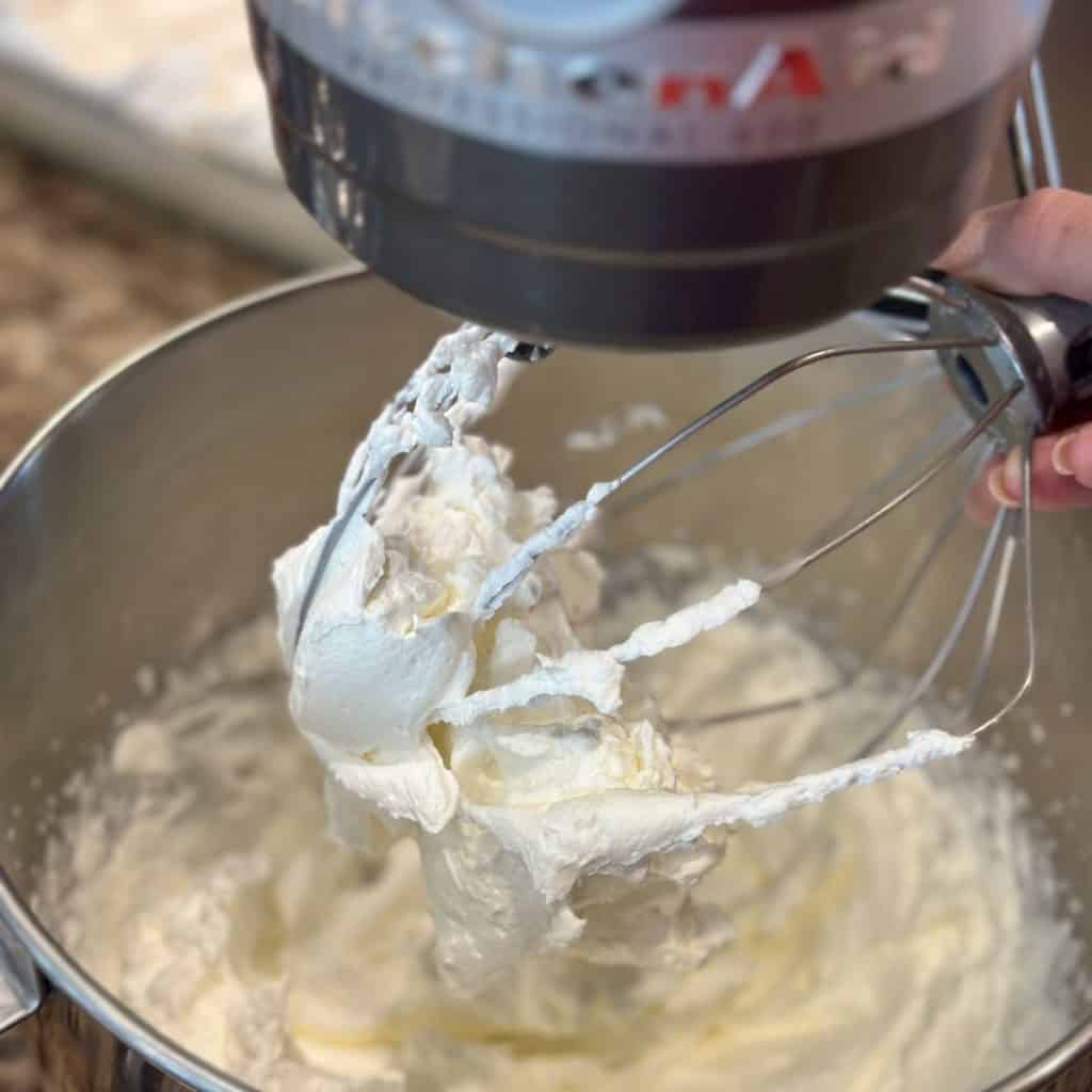 Whipping whipping cream in a mixer.