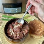 A spoon and bowl of red beans and rice.