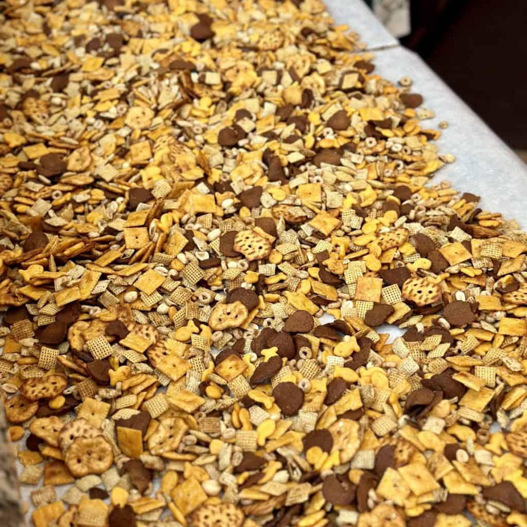 Chex mix cooling on parchment paper.