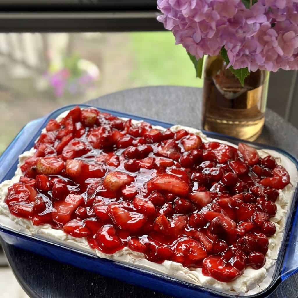 A baking dish of cherry berry on a cloud dessert.