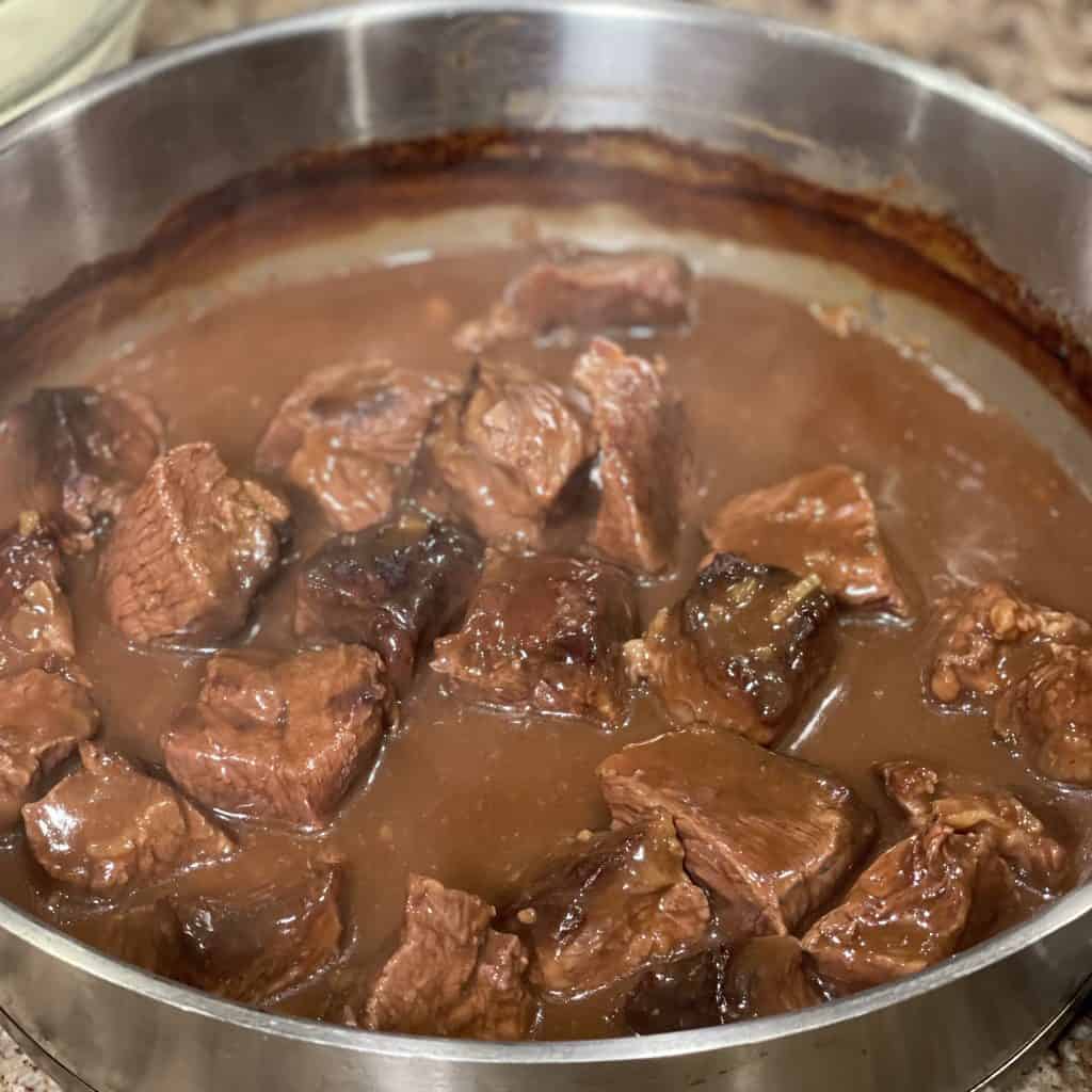 cooked beef squares in brown sauce