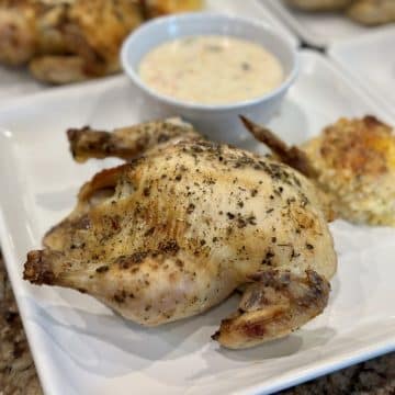 A Cornish game hen with soup and a biscuit