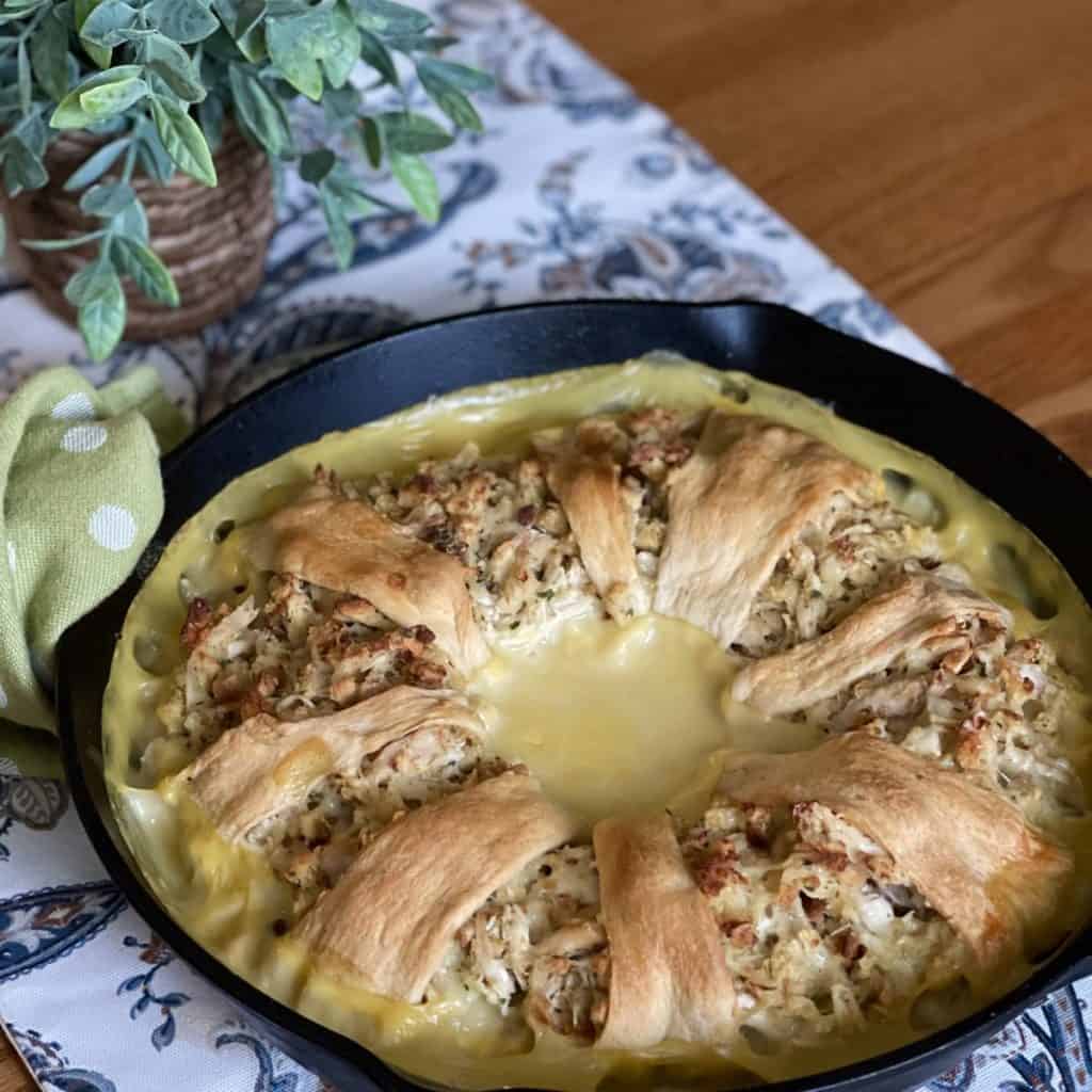 A crescent roll chicken ring in a cast iron skillet.