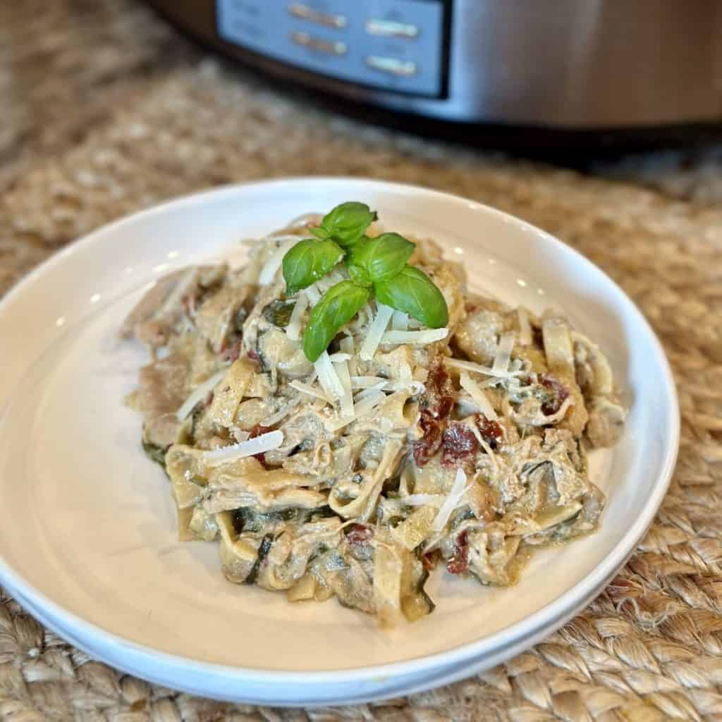 A plate of creamy Tuscan chicken pasta.