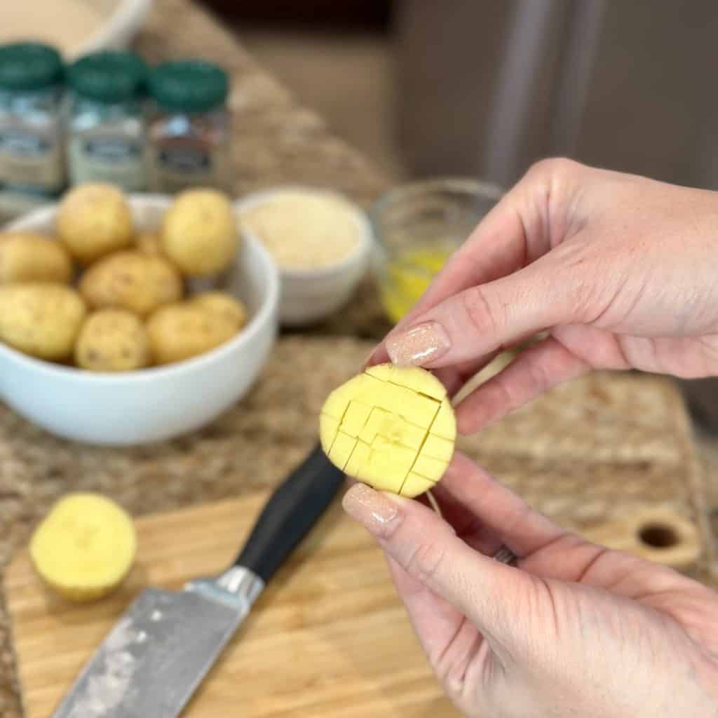 A close up view of a scored yellow potato.