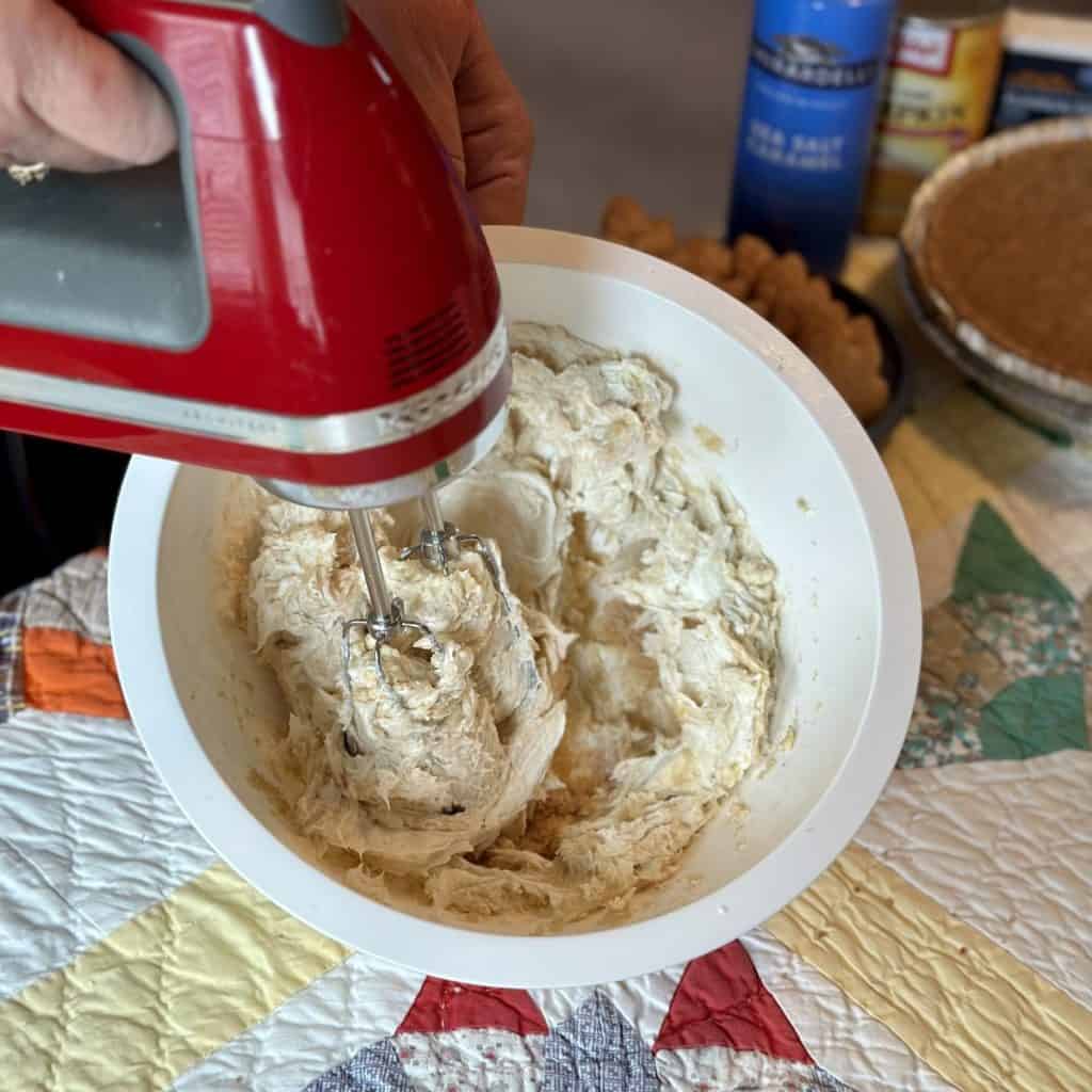 Whipping the pumpkin layer of a pie.