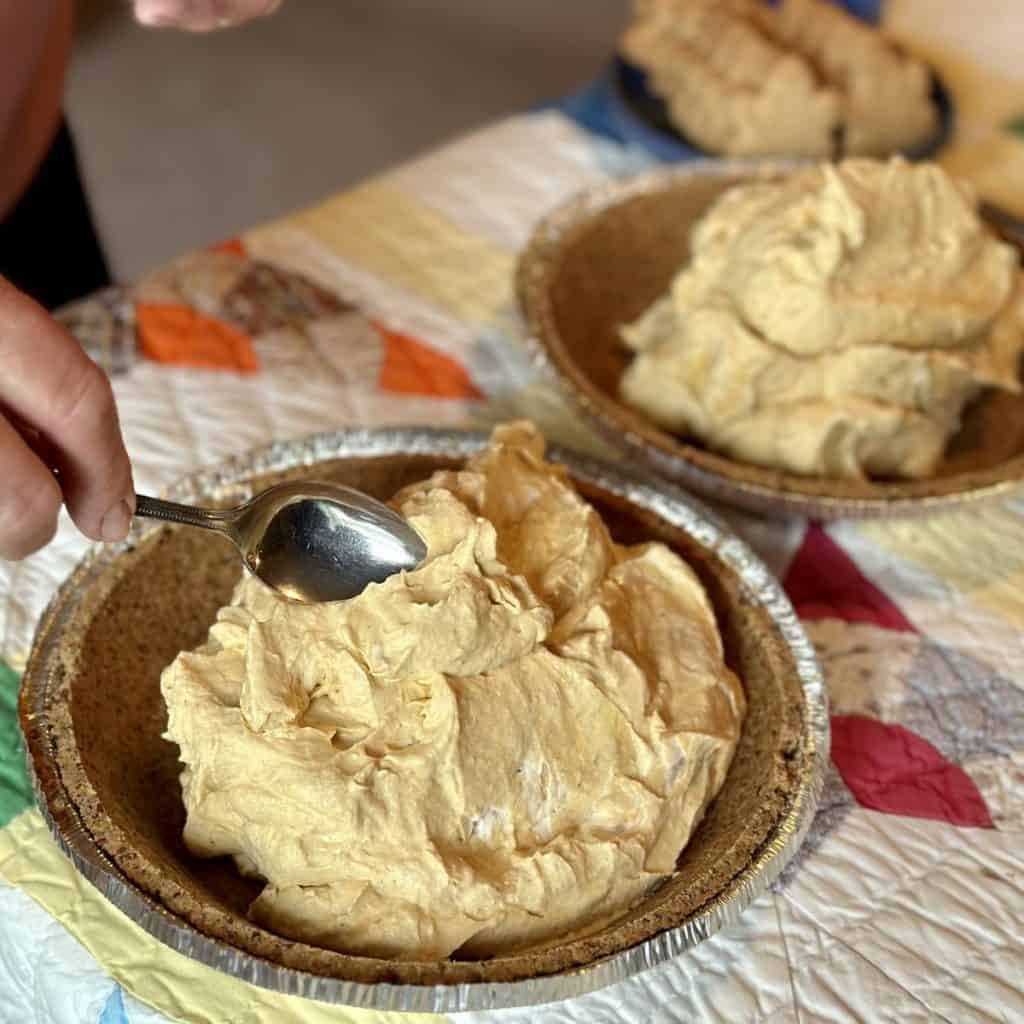 Spreading pie filling in a crust.