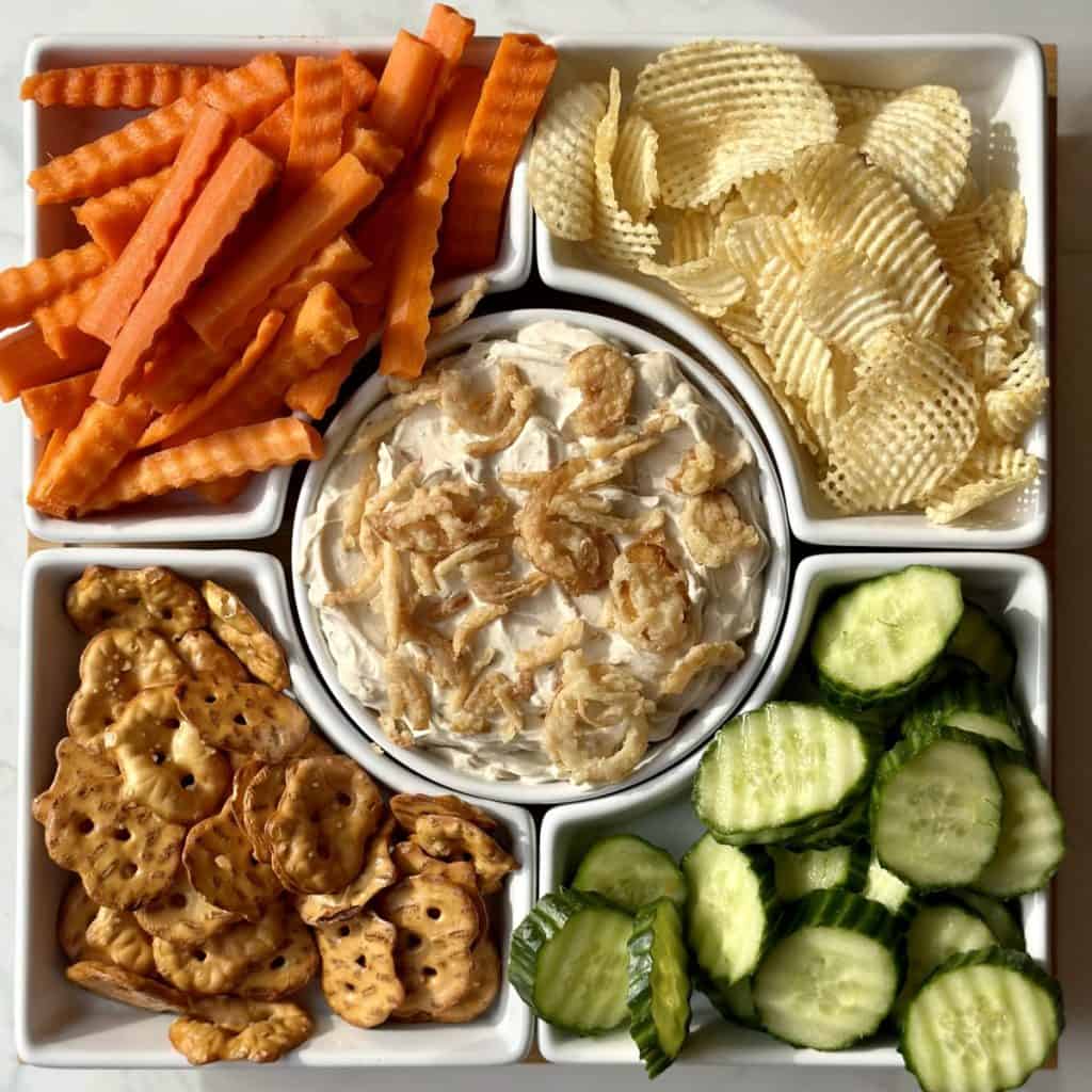 An overview shot of chips, veggies and onion dip.