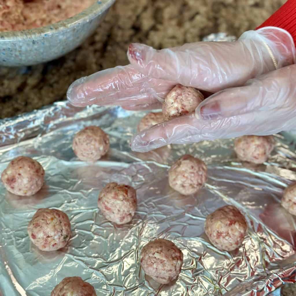 Rolling sausage balls.