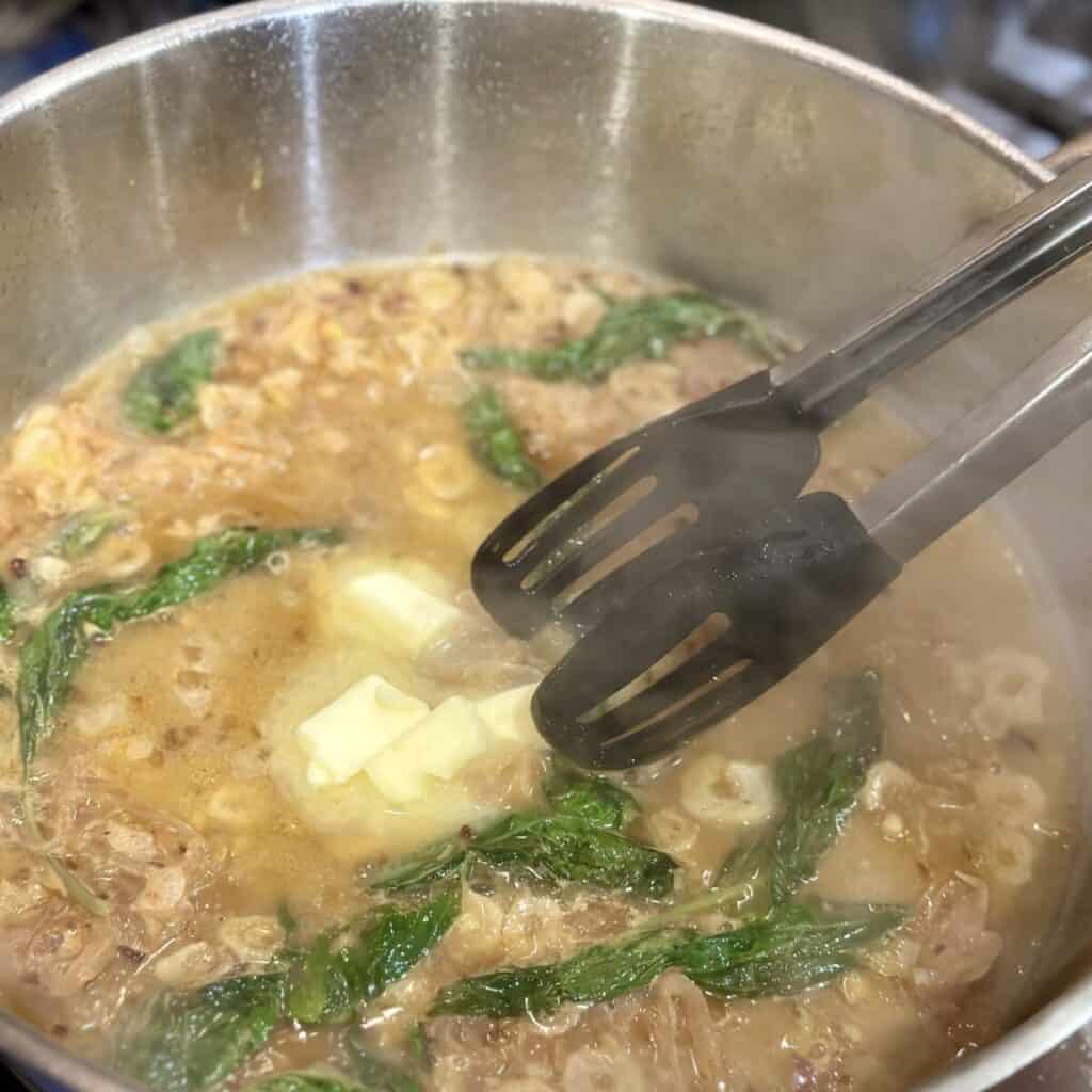 Adding butter to a skillet.