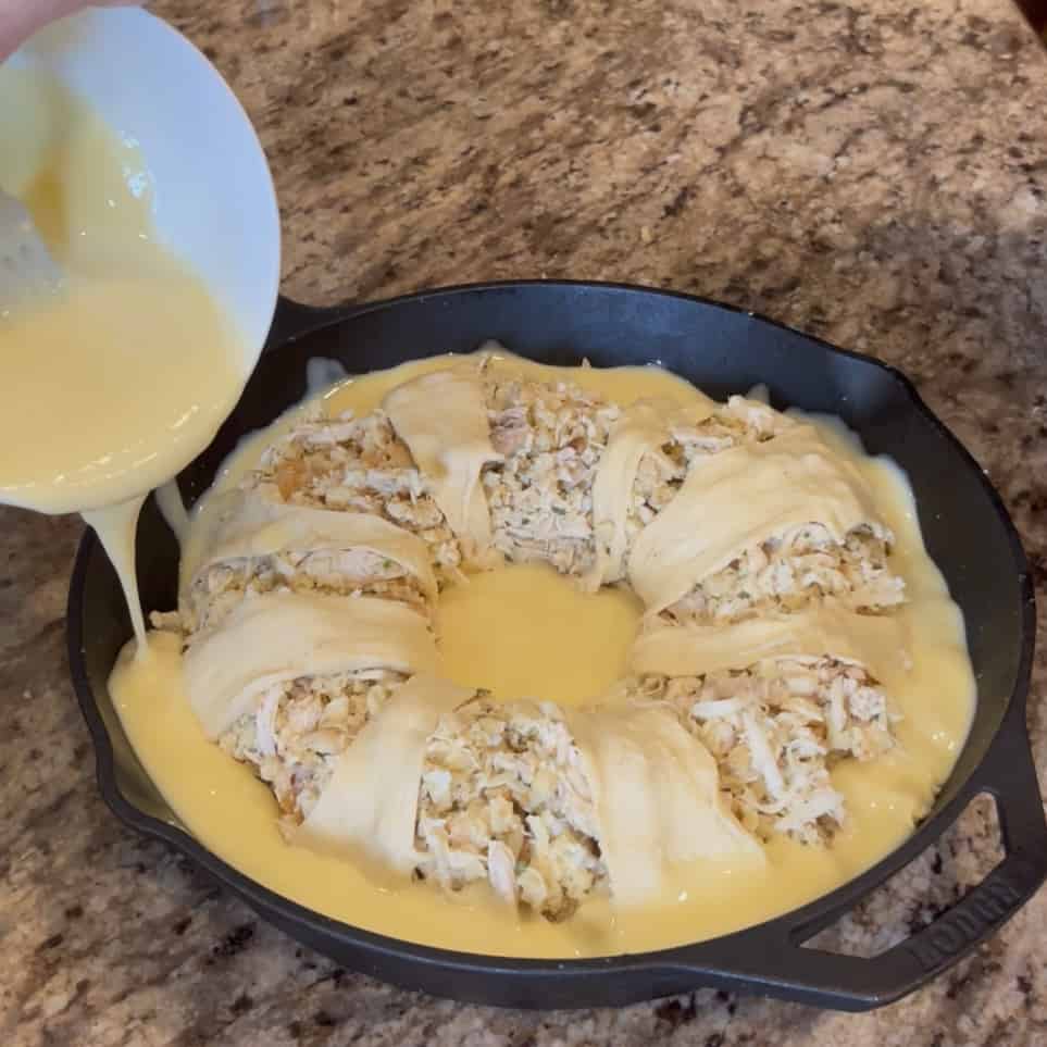 Pouring gravy around a chicken ring.