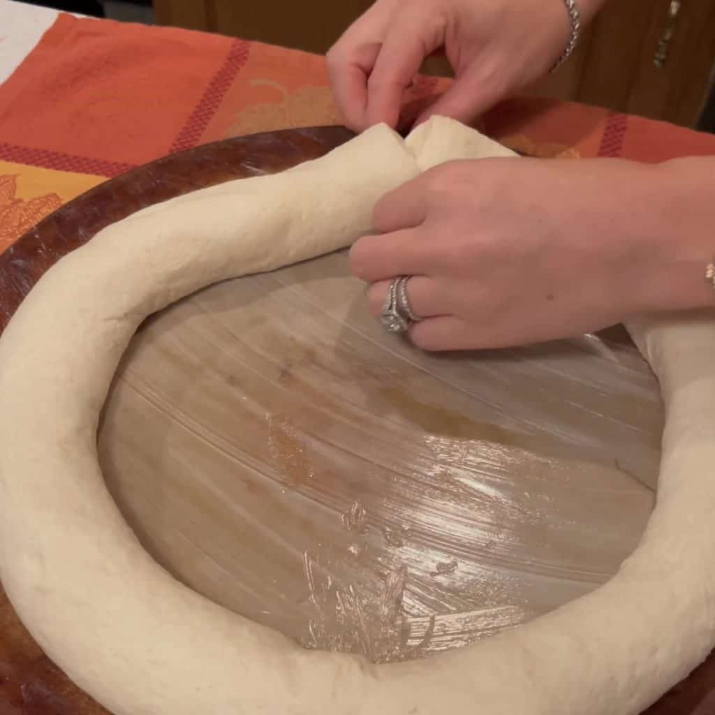 Pinching together the seams of a bread dough,