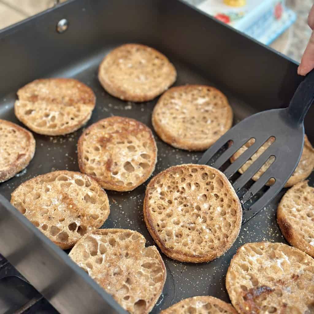 Toasting English muffins in a skillet.