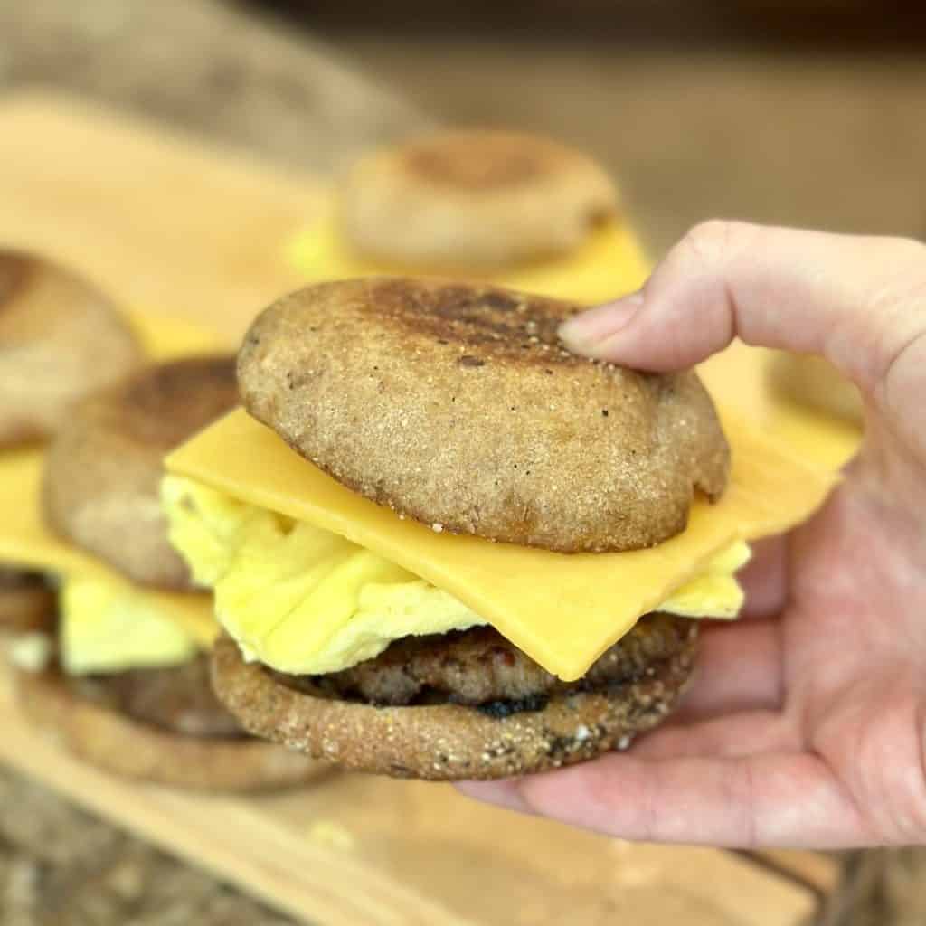 A close up shot of a sausage, egg and cheese sandwich.