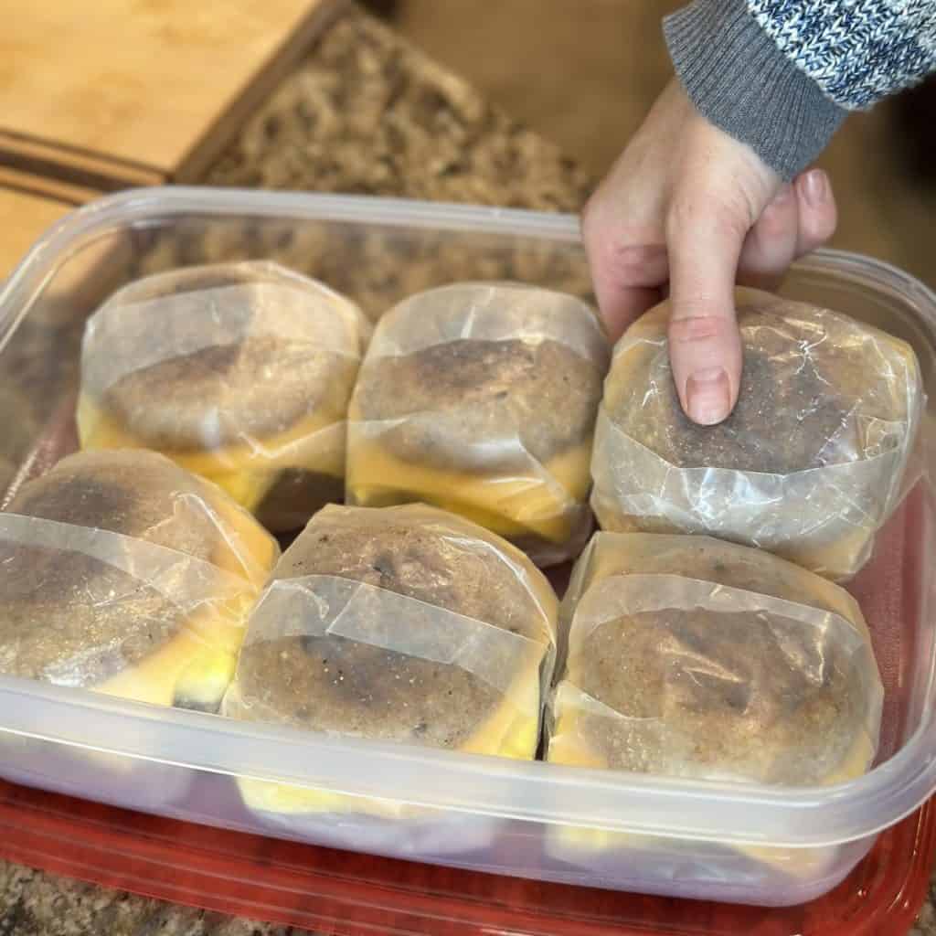 A container full of ready-made breakfast sandwiches.