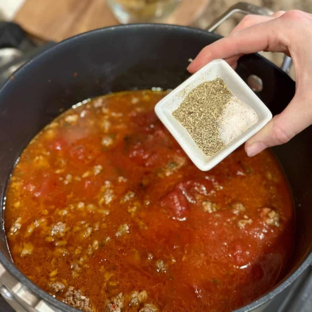 Adding seasonings to soup.