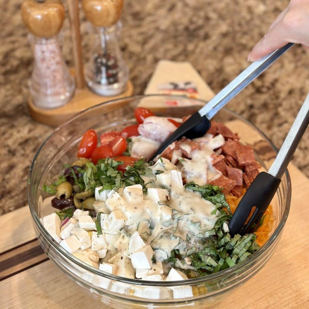 The ingredients in a bowl to make pasta salad.