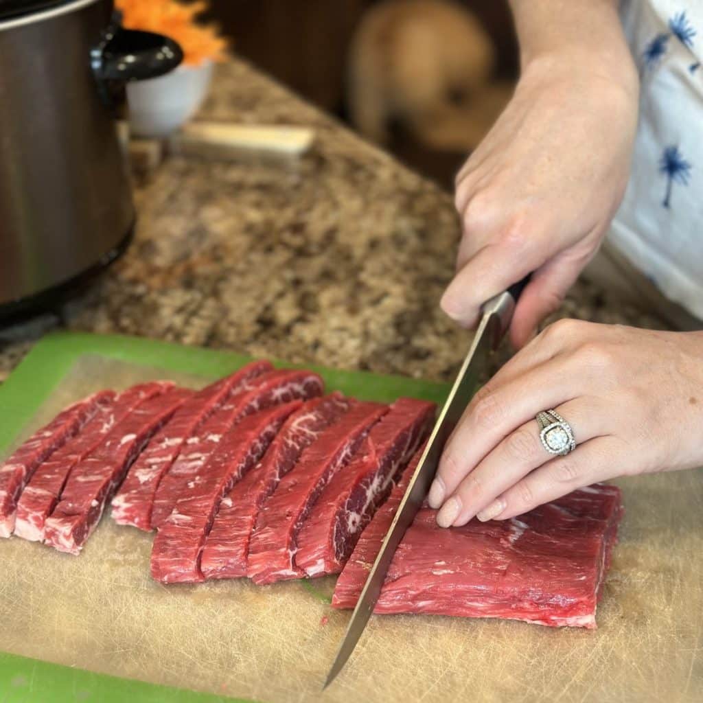 Slicing flank steak against the grain.