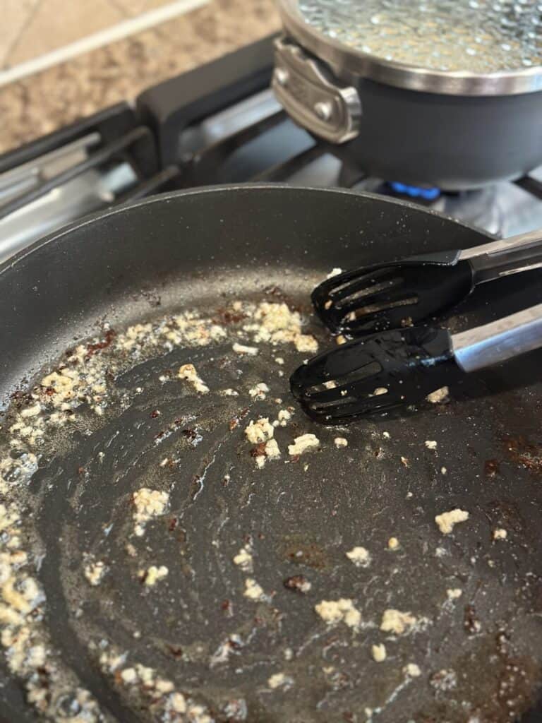 Sautéing garlic in a skillet.