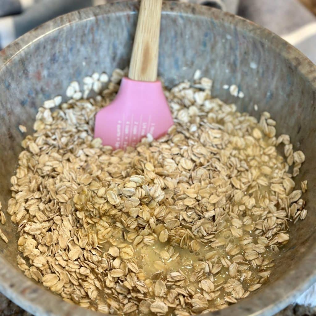 Blending wet and dry ingredients in a bowl for baked oatmeal.