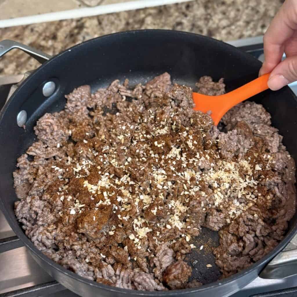 Taco meat in a pan for taco lasagna.