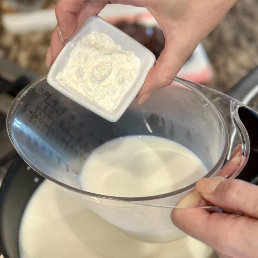 Mixing together cornstarch and milk.