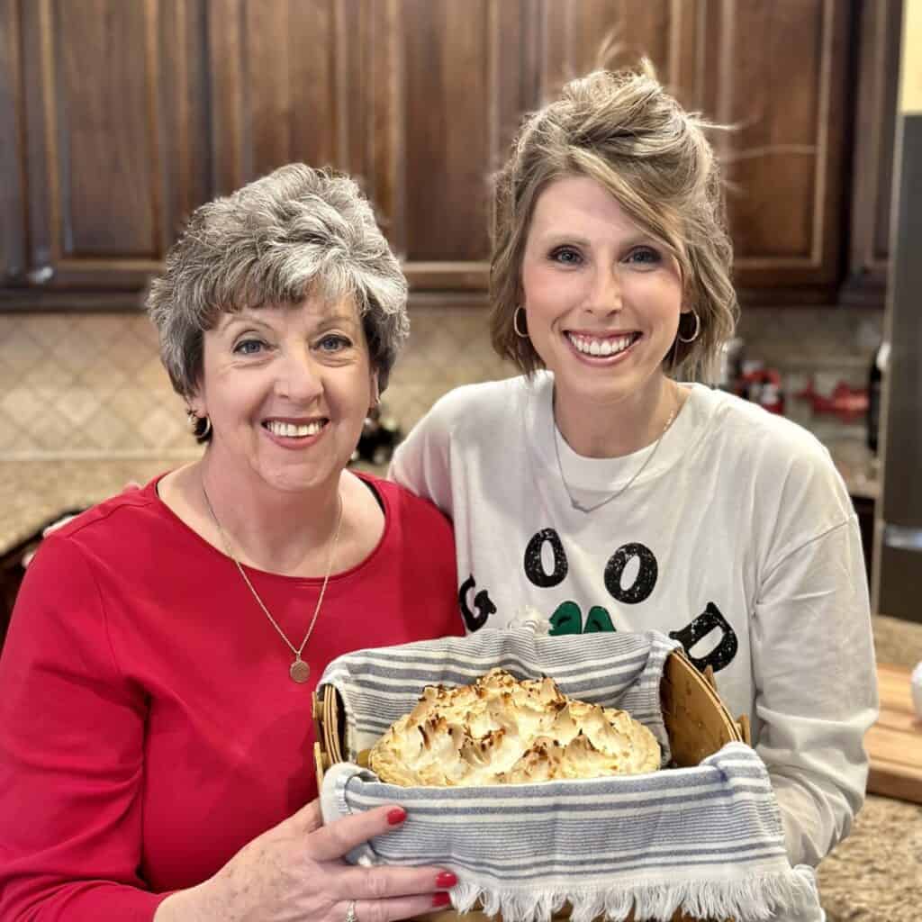 A picture of Laura and her mom holding a pie.