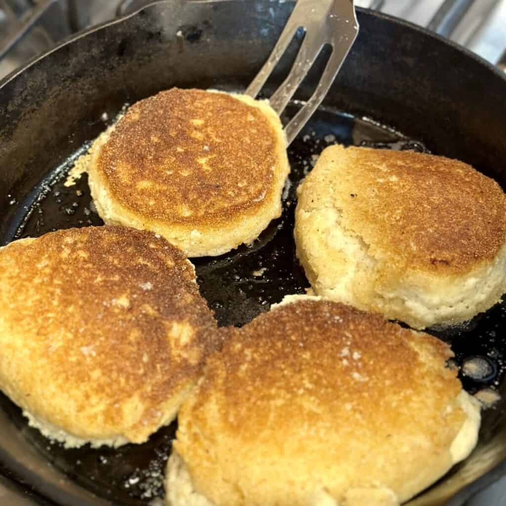 Frying hoecakes in a skillet.