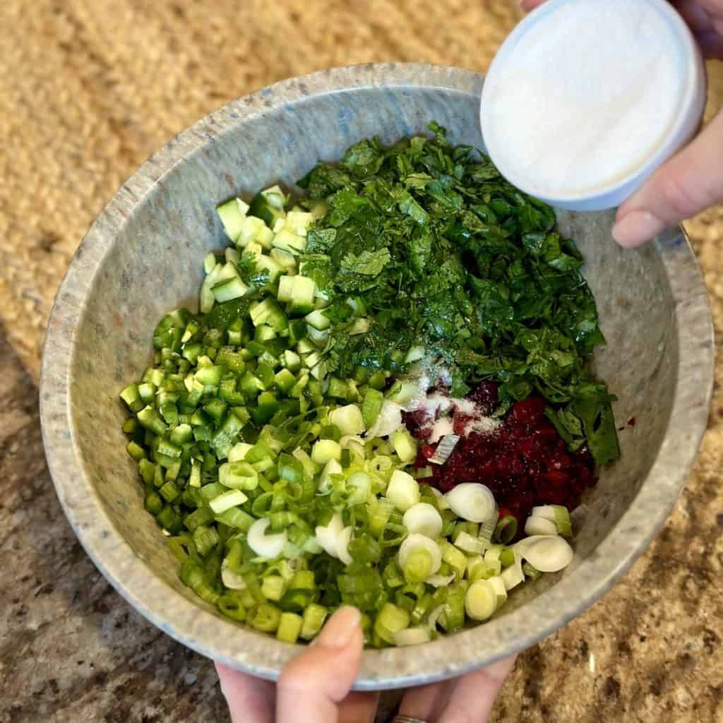 A blend of ingredients in a bowl for holiday salsa.