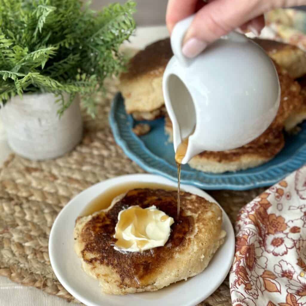 Adding syrup to the top of a hoecake.